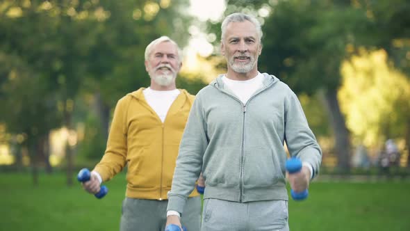 Active Retired Friends Lifting Dumbbells, Fitness Training Park, Healthy Aging