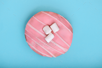 pink donut on a blue background, the concept of minimalism, a game of color. Blue background, copy