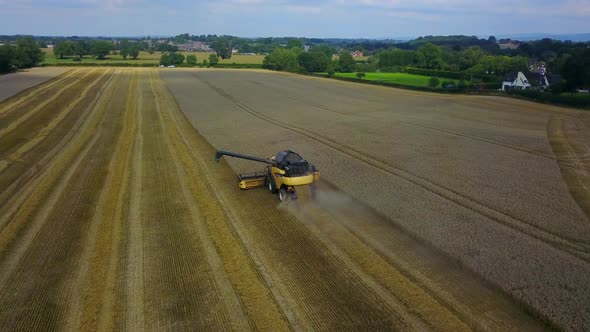 combine harvester working in  field, cheshire,england