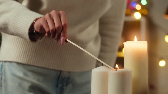 Woman Lighting Candles and Decorating Christmas Tree