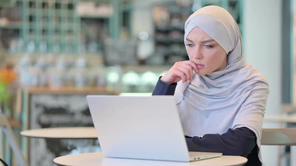 Attractive Woman Thinking and Working on Laptop