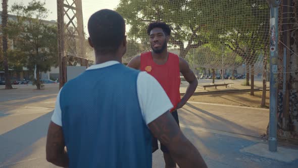 Cinematic footage of a street basketball game outdoor.