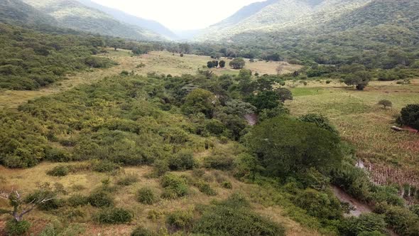 Aerial View of the Green Plains in Mountains and Trafic Road, Tanzania, Africa. The the Green Hills