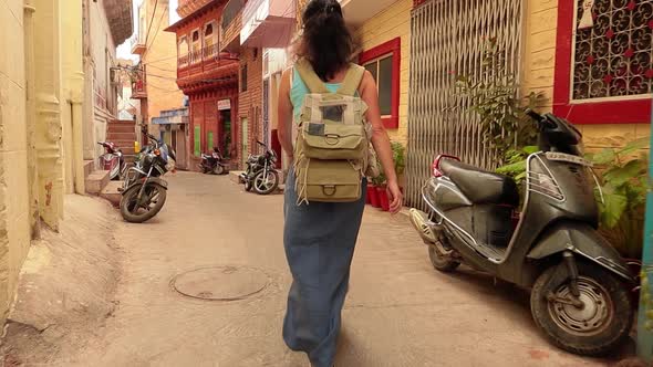 Female Tourist Walks Through the Streets of an Indian City