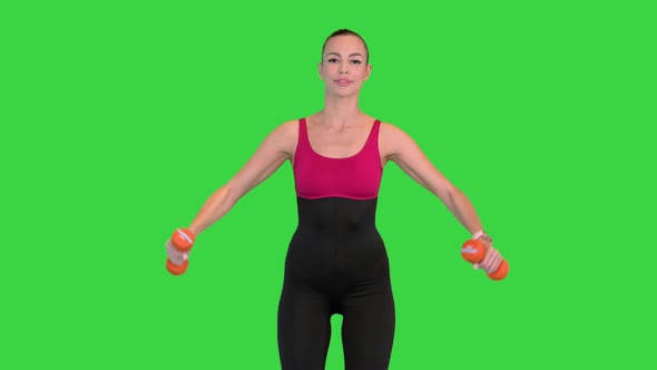 Fitness Model Working Out with Dumbbells on a Green Screen Chroma Key