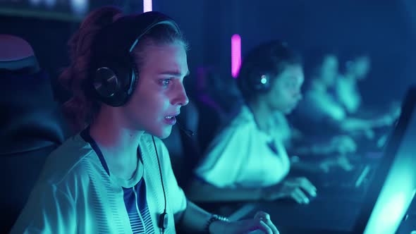 Focused Team of Gamers in Headphones Plays a Video Game Cyber Sportsmans at the International