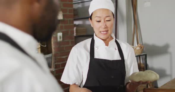 Animation of asian female baker explaining how to make a bread to her coworker