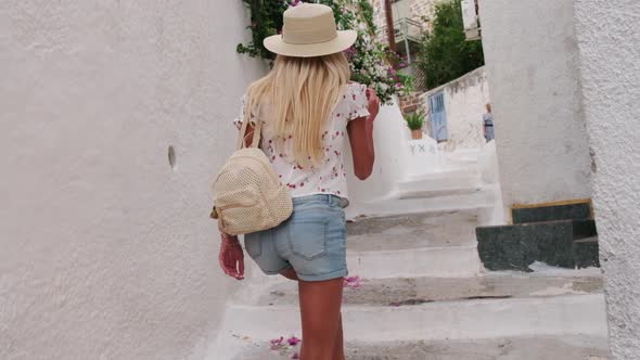 Beautiful Girl Tourist Walking in the Streets of Poros City Greece