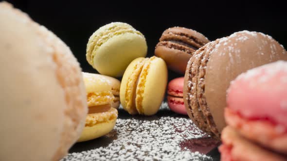 Colored Macaroons Confectionery Marshmallows on a Black Reflective Background in Perspective