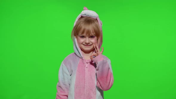 Little Child Girl Smiling Showing Ok Gesture Agree Sign in Unicorn Pajama on Chroma Key Background