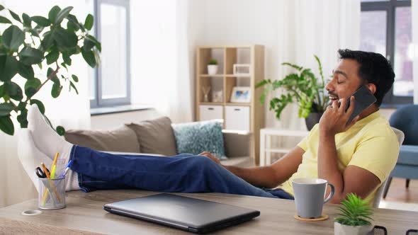 Happy Man Calling on Smartphone at Home Office