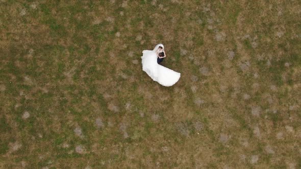 Groom Holds His Beloved Bride in His Arms and Spin in Dance