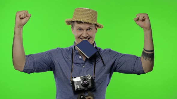 Portrait of Young Man Tourist Photographer Celebrates and Dances. Chroma Key