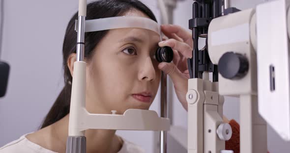 Woman do eye test at clinic