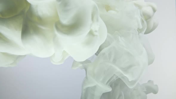 White nacreous paint in water against white background. alt