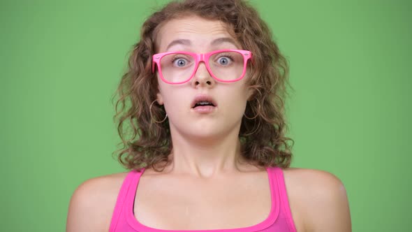 Young Beautiful Nerd Woman Looking Shocked While Covering Mouth