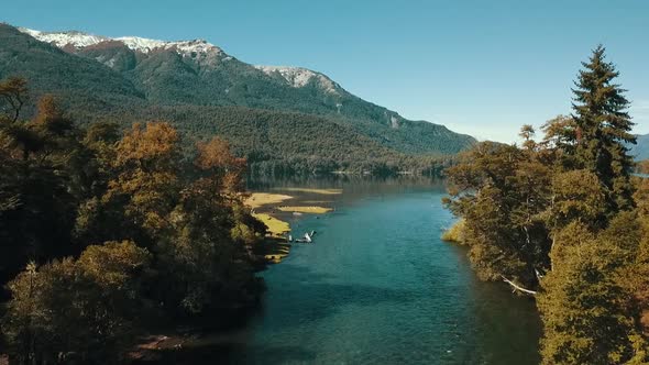 Dronees above the river to see the autumn landscape with the lake in the background.