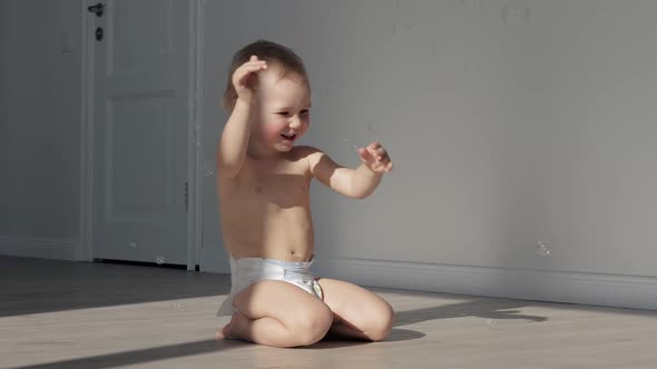 Funny Little Baby Playing With Soap Bubbles At Home