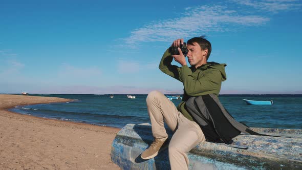 Photographer Sits on Boat Shoots Landscape