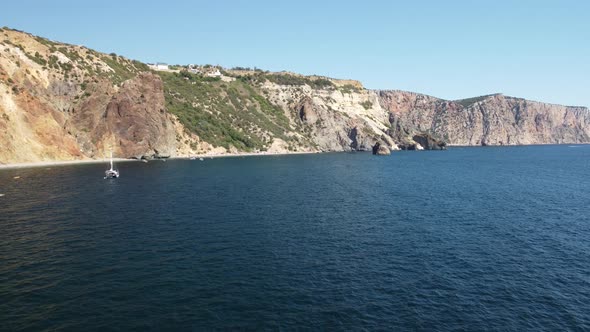 Aerial View From Above on Calm Azure Sea and Volcanic Rocky Shores