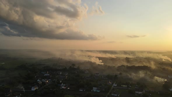 Aerial Shot in Ukraine at Sunset Burning Grass