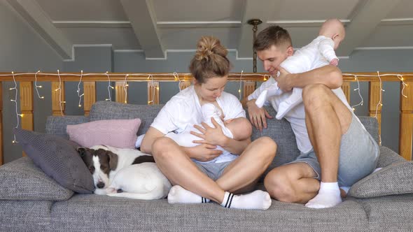 Happy Family Concept. Breast Feeding Newborn Baby At Home. Twins.