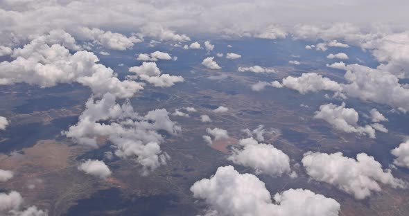 View From Plane During Flight Over of Fluffy Clouds desertNew Mexico USA