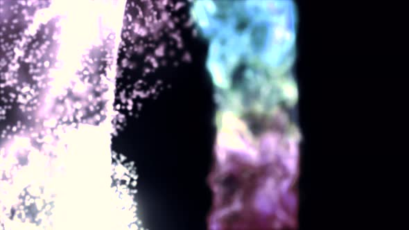 Defocused particles form abstract animated dark background