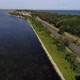 Aerial view of beautiful scenic coast road by the sea. Cars and motorcycles are passing by - VideoHive Item for Sale