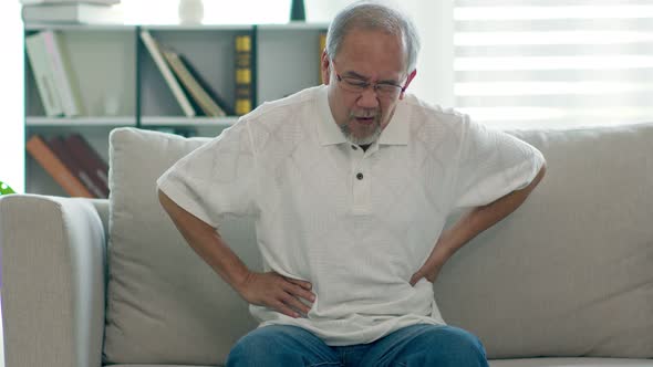 Asian Elderly senior man stomach ache so pain illness