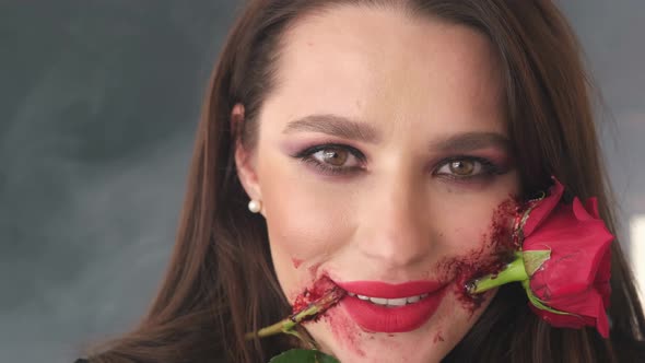 Unusual Arch Makeup Girl with a Red Rose Flower on Her Face