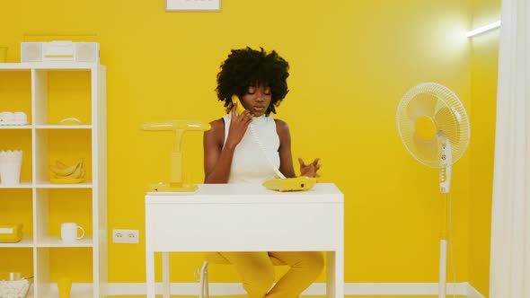Black Woman Is Talking Phone In Yellow Room