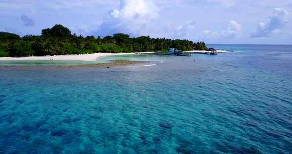 Wide angle flying island view of a white sandy paradise beach and blue ocean background in colorful 