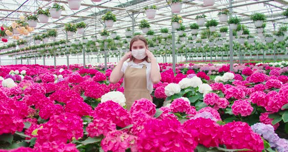 Smiling Woman Enjoying and Sniffing Pink Flowers