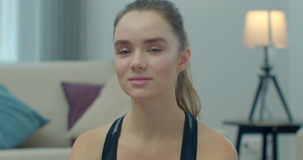 Portrait of Beautiful Fitness Woman Looking at Camera Smiling at Home in Room Sportswear Lifestyle