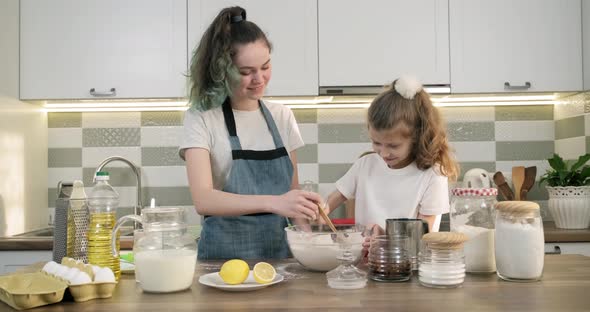 Two Girls Preparing Cookies Together in Kitchen, Kids Stir Flour