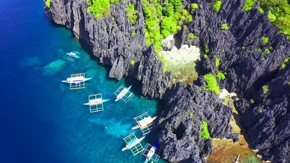 Aerial Drone View of Swimmers Inside a Tiny Hidden Tropical Lagoon Surrounded By Cliffs - Secret