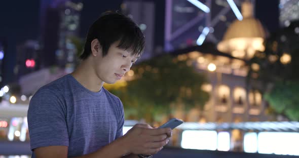 Man use of mobile phone at night 