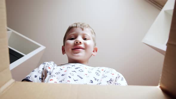 Funny Cute Boy Opening the Box with Gifts