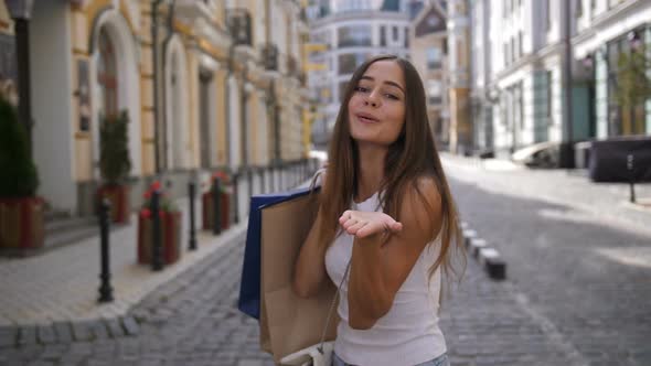 Attractive Shopping Girl Looking Back and Smiling