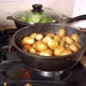 Womans Hand Opens The Lid Of A Frying Pan With Potatoes. Oil Splashes Fly - VideoHive Item for Sale
