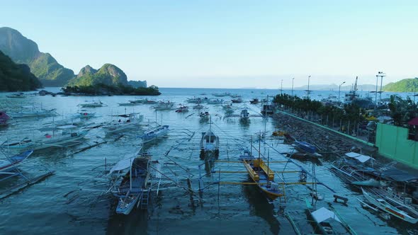 Aerial drone view of traditional fishing boats in El Nido bay, Palawan, Philippines. A beautiful day