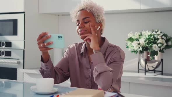 Young Outgoing African American Woman Making Video Call Via Phone at Breakfast