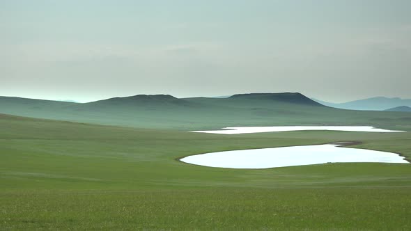 Two Lakes in Treeless Green Plain