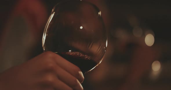 Red Wine is swirled in a glass close up