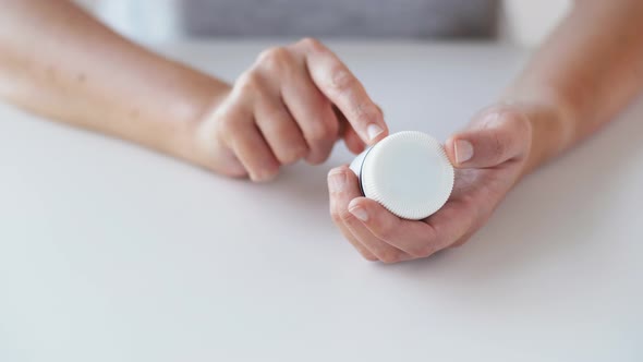 Woman Hands Opening Jar of Medicine Pills