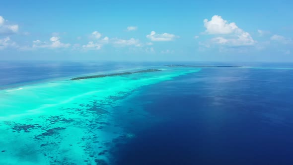 Aerial flying over nature of luxury coast beach voyage by blue water with white sandy background of 