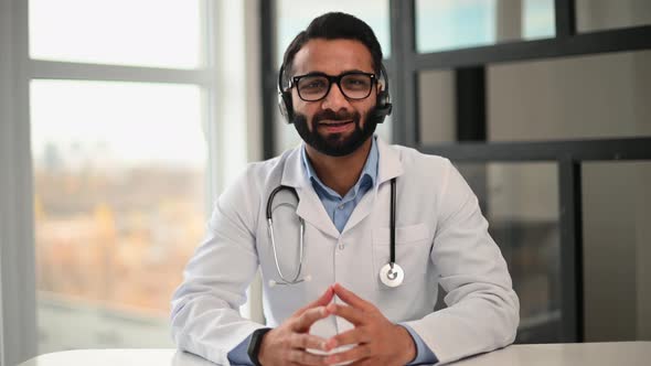 Webcam View of Indian Doctor with a Stethoscope in White Gown Talking Online