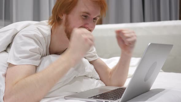 Happy Man in Bed Reacting to Success of Work