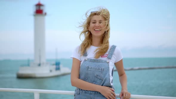 Happy Girl with Long Hair Posing Standing on a Boat Laughing